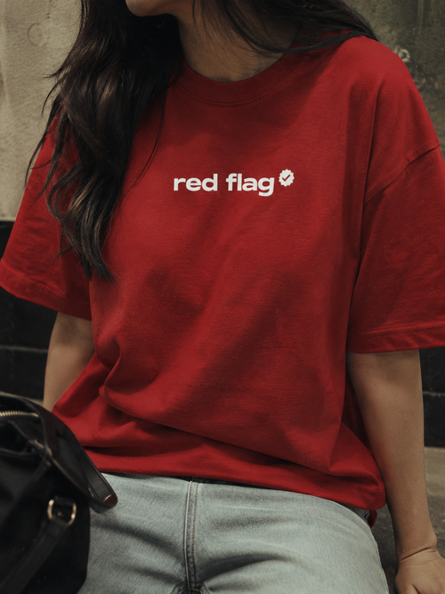 Person wearing a red t-shirt with 'red flag' text